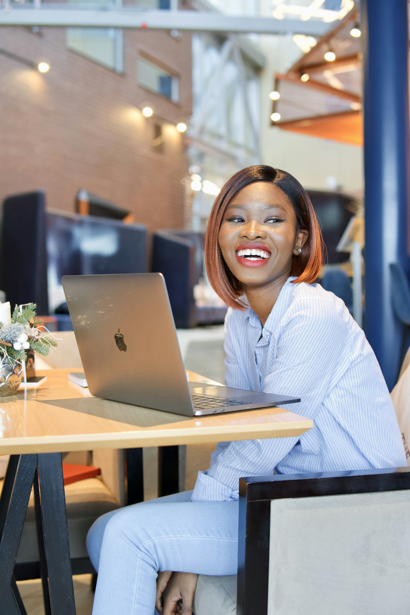 A smiling researcher working at her laptop